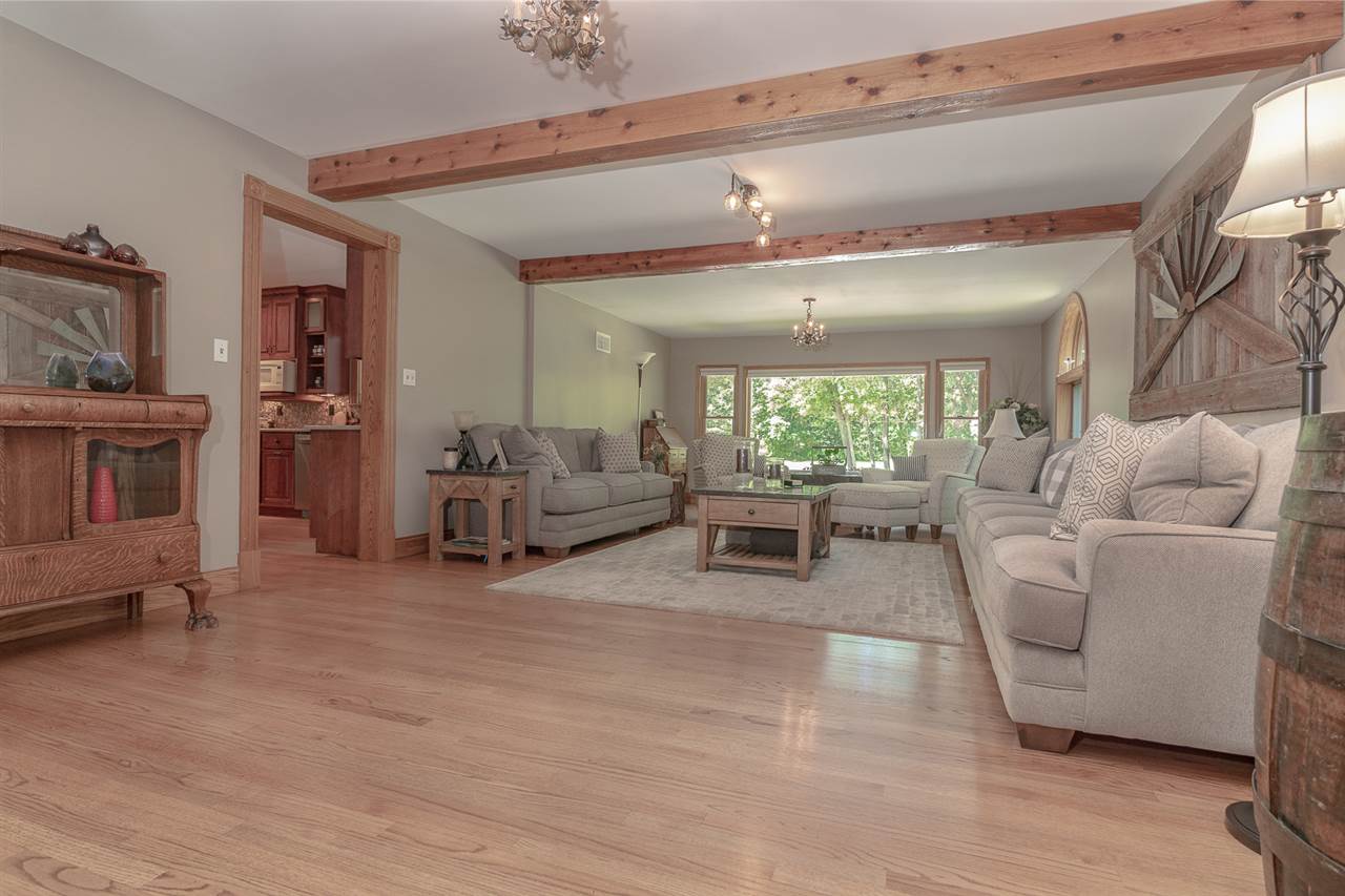 1052 South Harmony Road Oregon, IL 61061 - Photo 6 of 25 a living room with furniture and a large window