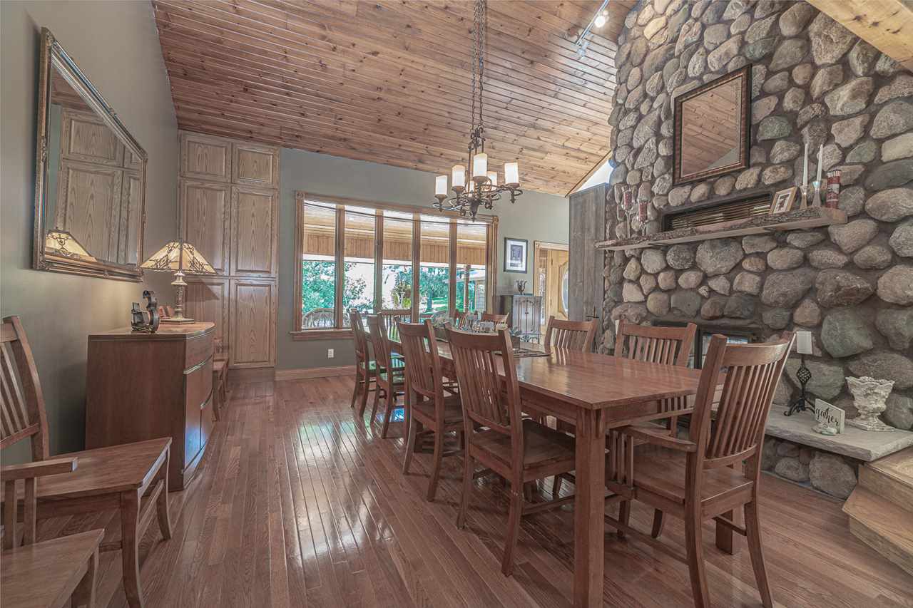 1052 South Harmony Road Oregon, IL 61061 - Photo 7 of 25 a dining room with furniture a chandelier and wooden floor