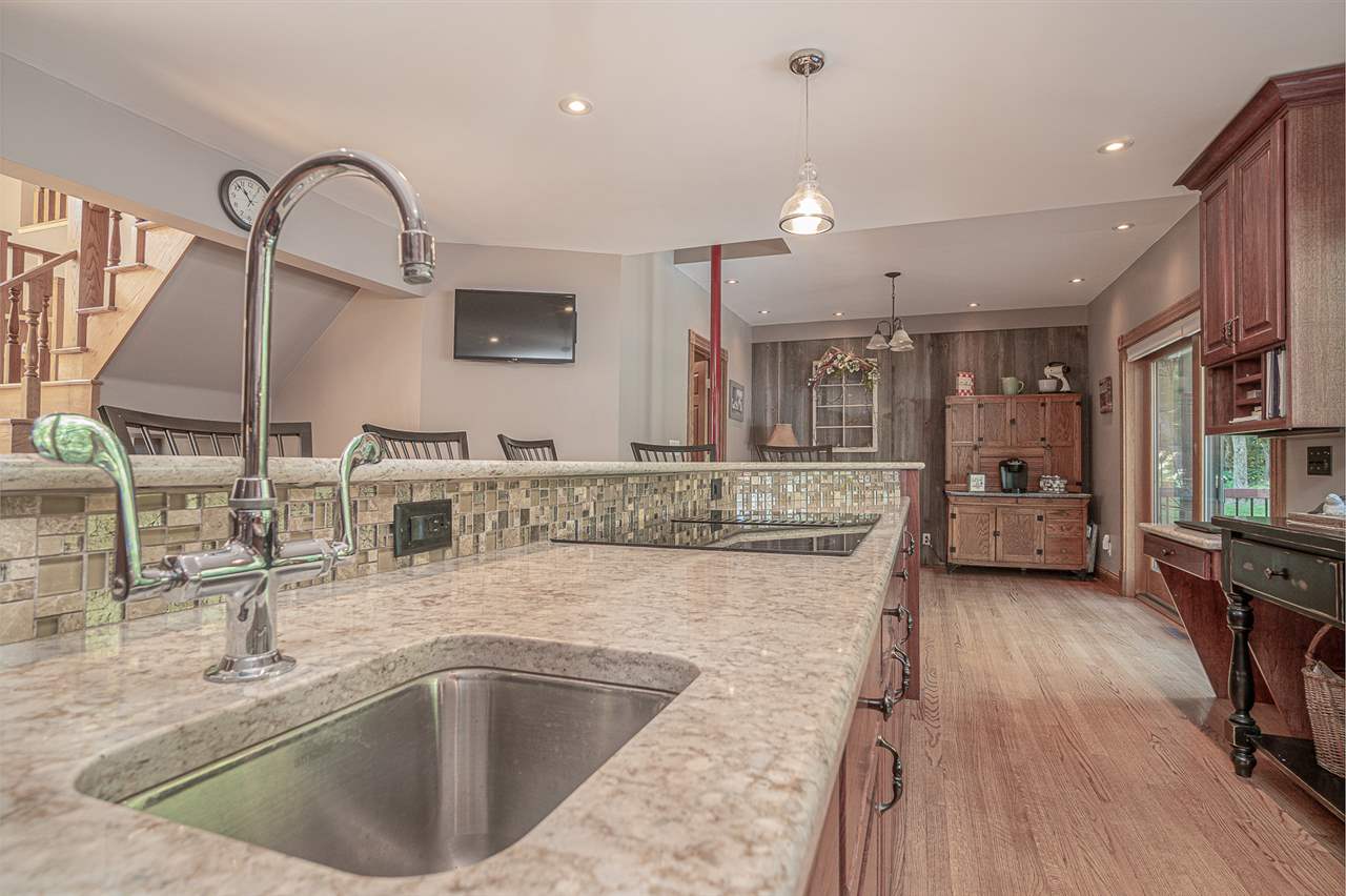 1052 South Harmony Road Oregon, IL 61061 - Photo 10 of 25 a kitchen with a sink a counter top space appliances and cabinets
