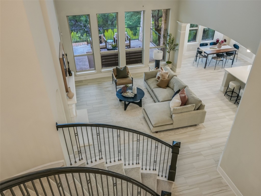 2610 Sunset Vista Circle, Unit 16 Spicewood, TX 78669 - Photo 17 of 28 Staircase with arched walkways and wood finished floors