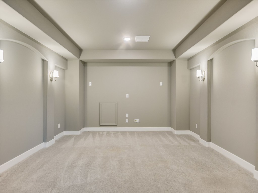 2610 Sunset Vista Circle, Unit 16 Spicewood, TX 78669 - Photo 19 of 28 Spare room with arched walkways and light colored carpet