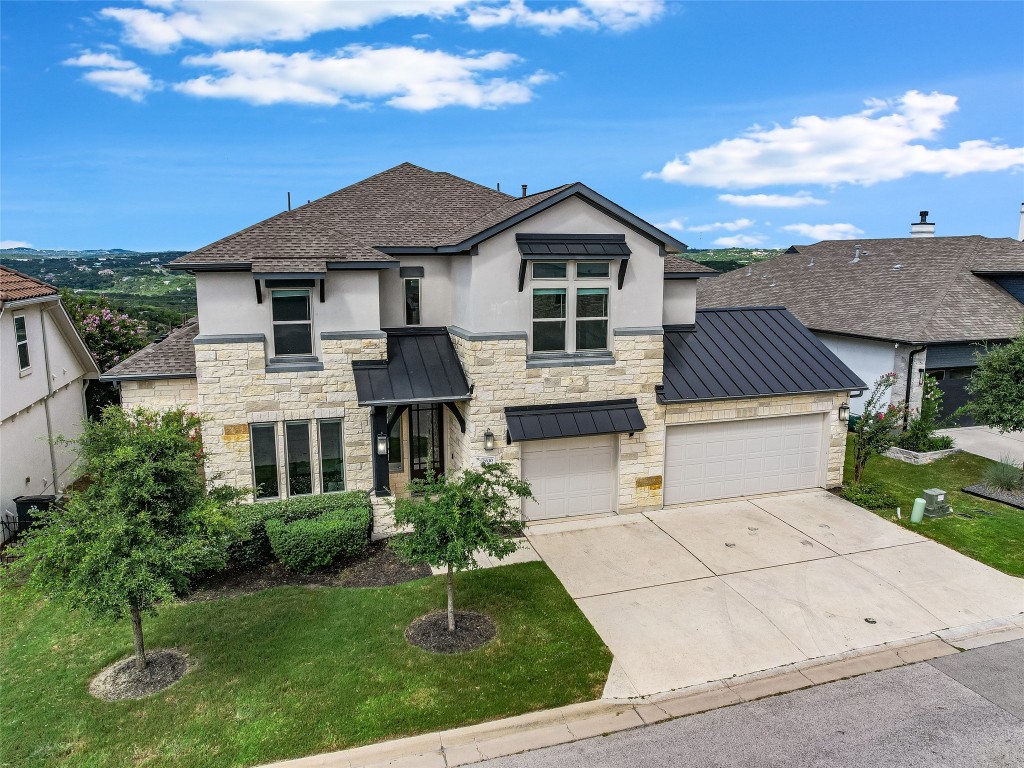 2610 Sunset Vista Circle, Unit 16 Spicewood, TX 78669 - Photo 26 of 28 View of front of property with a standing seam roof, a metal roof, and stone siding