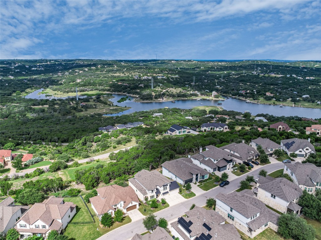 2610 Sunset Vista Circle, Unit 16 Spicewood, TX 78669 - Photo 28 of 28 Aerial perspective of suburban area with a large body of water