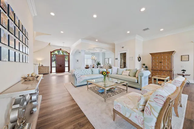 a view of a dining room with furniture a chandelier and wooden floor