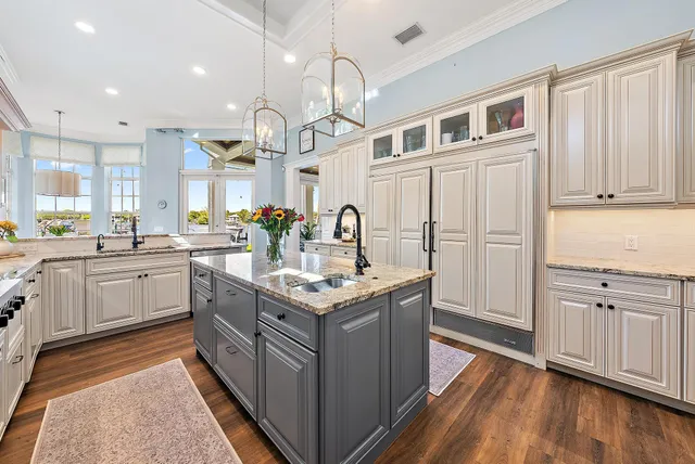 a dining room with furniture a chandelier and wooden floor