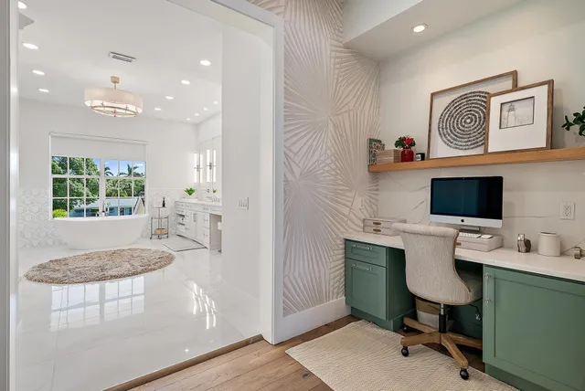 a kitchen with stainless steel appliances a refrigerator a stove a sink a dining table and chairs with wooden floor