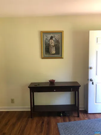 a view of a workspace with furniture and wooden floor