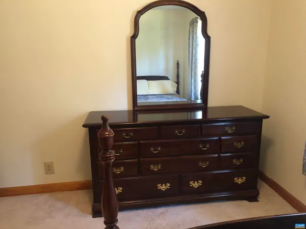 a view of a dresser with mirror