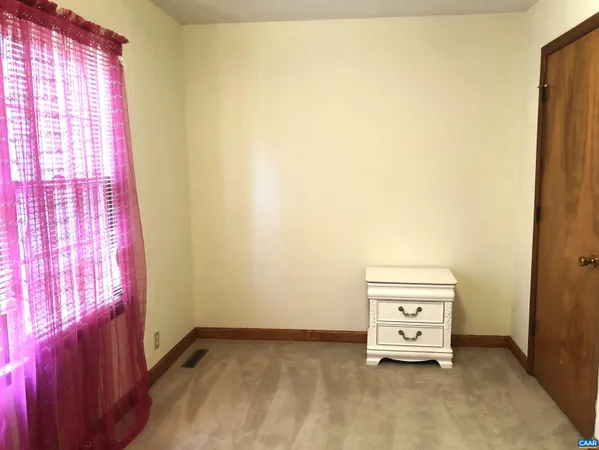 a room with a bed and a window