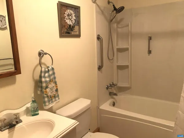 a bathroom with a toilet a sink and bathtub