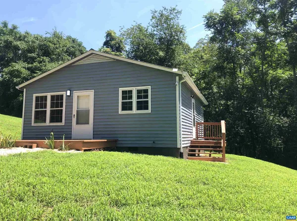 a front view of a house with a yard table and chairs