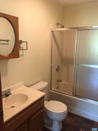 a bathroom with a shower and a toilet