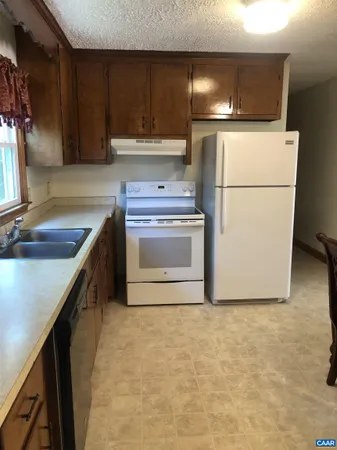 a kitchen with a refrigerator sink and cabinets