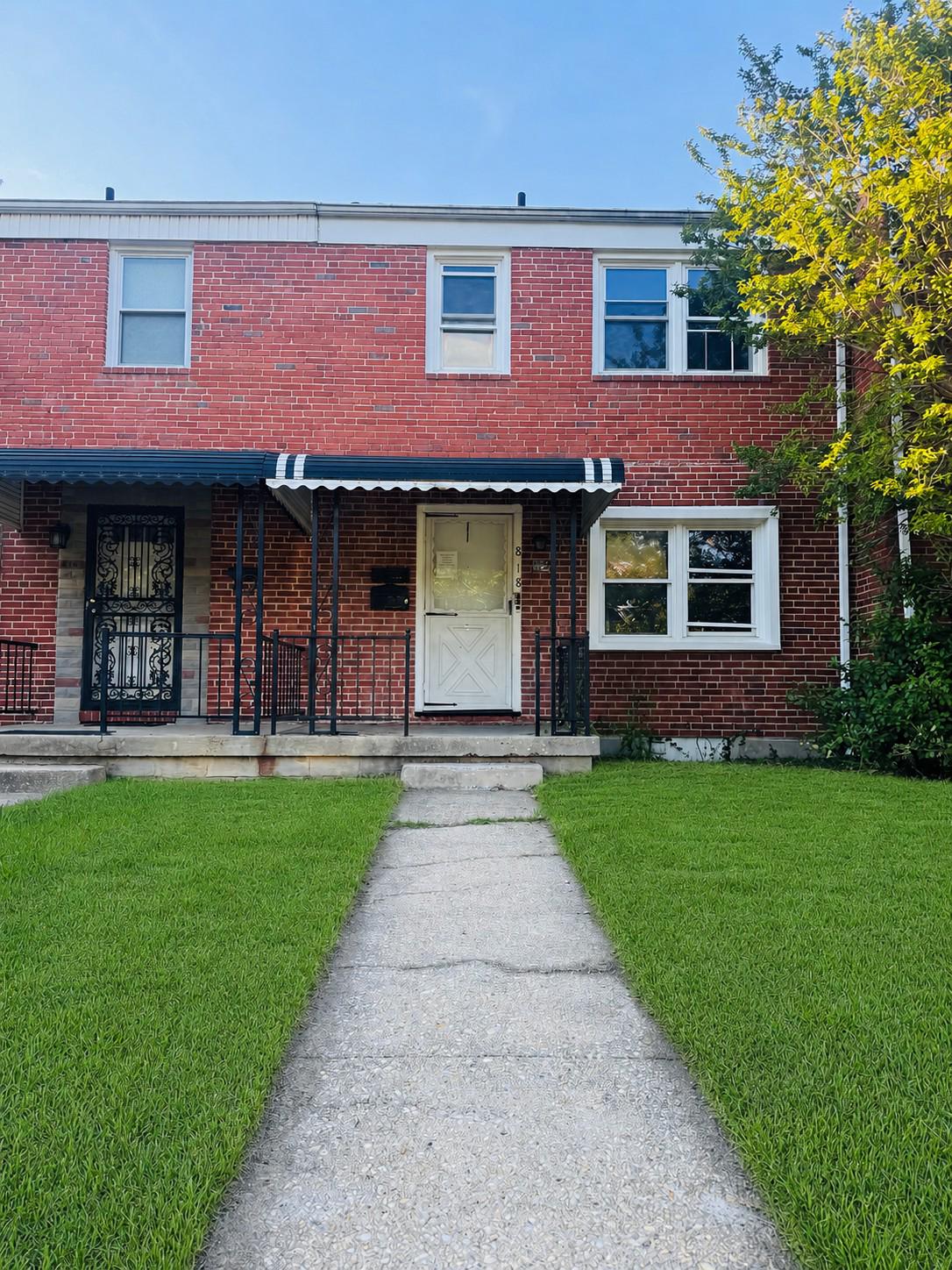 818 Bradhurst Road Baltimore, MD 21212 - Photo 1 of 4 a front view of a house with a yard
