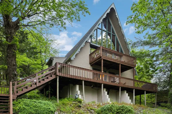a view of house with a yard and potted plants