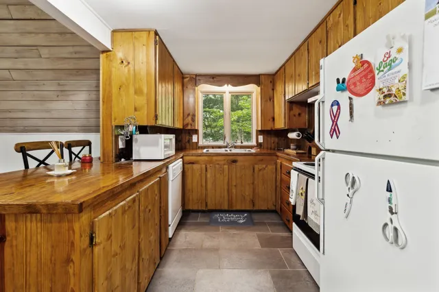 a kitchen with a sink and a stove top oven