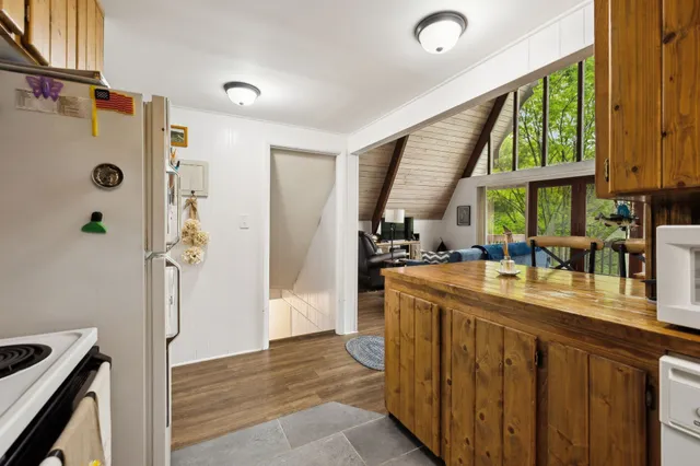 a kitchen with stainless steel appliances granite countertop a sink a stove and a refrigerator