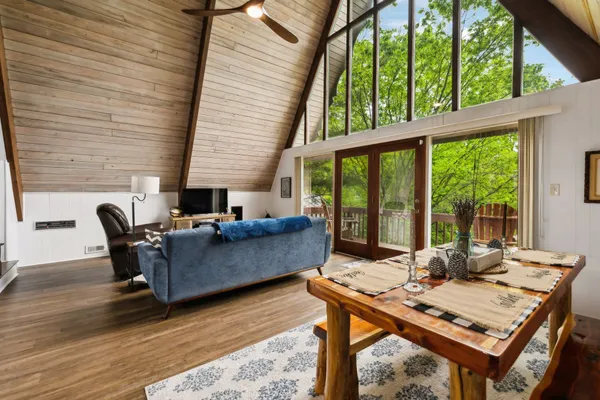 a living room with furniture and large windows