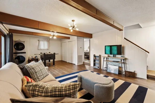 a living room with furniture and large windows