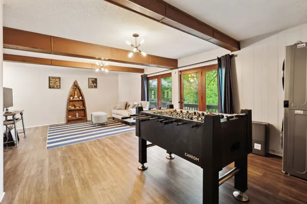 a living room with furniture and wooden floor