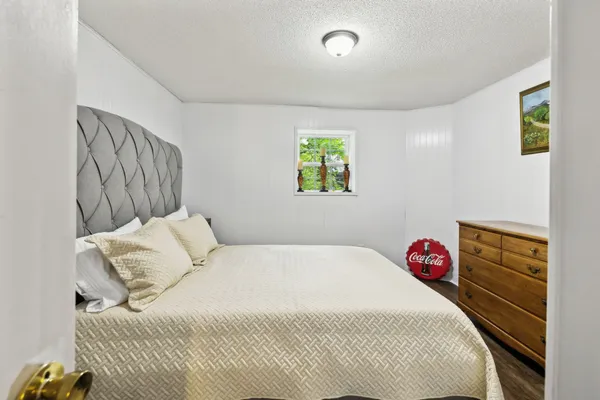 a bedroom with a bed and a window