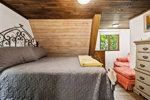 a bedroom with a bed and a dresser