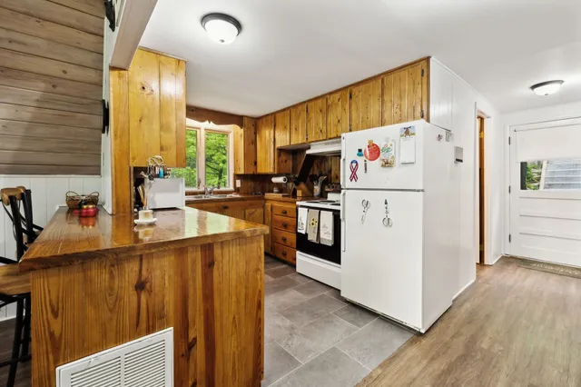 a kitchen with stainless steel appliances a refrigerator sink and cabinets