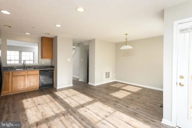 a view of a kitchen with a sink and a stove top oven