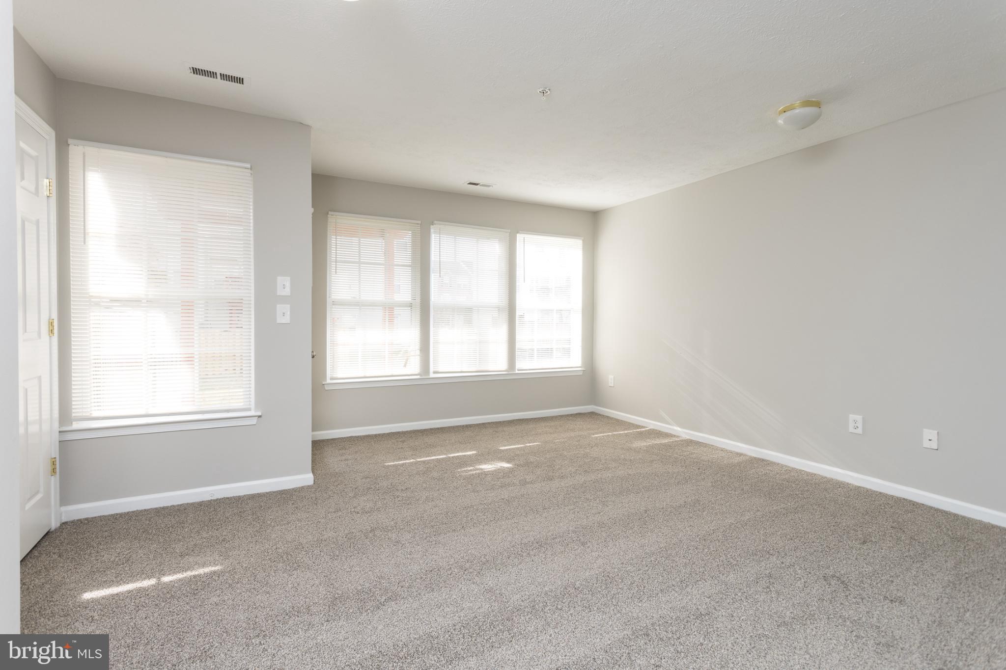 9899 Decatur Road Baltimore, MD 21220 - Photo 5 of 36 a view of an empty room with a window