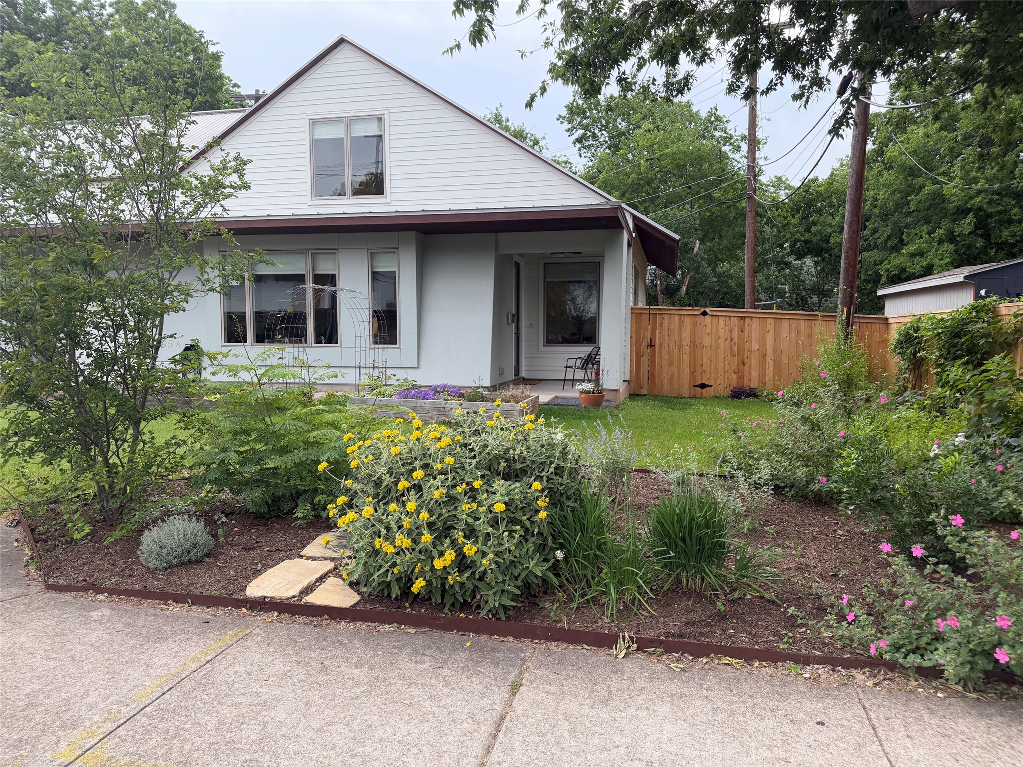 5305 Guadalupe Street, Unit A Austin, TX 78751 - Photo 1 of 31 White exterior with prominent gable roofline