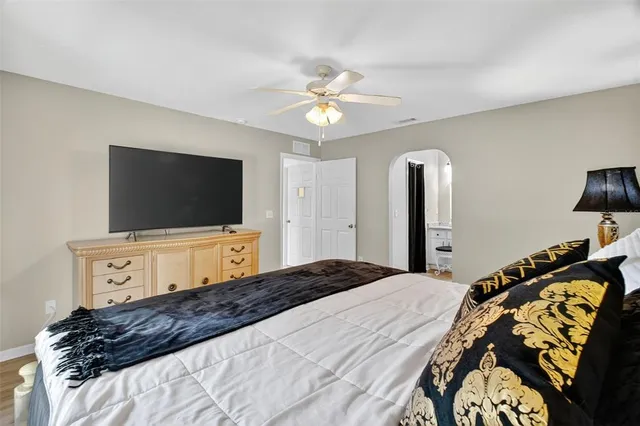 a bedroom with a bed and a flat screen tv