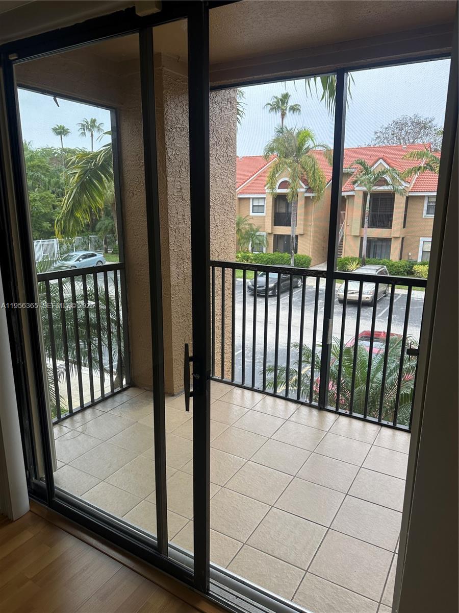 15560 Southwest 104th Terrace, Unit 625 Miami, FL 33196 - Photo 14 of 14 a view of a balcony with wooden floor