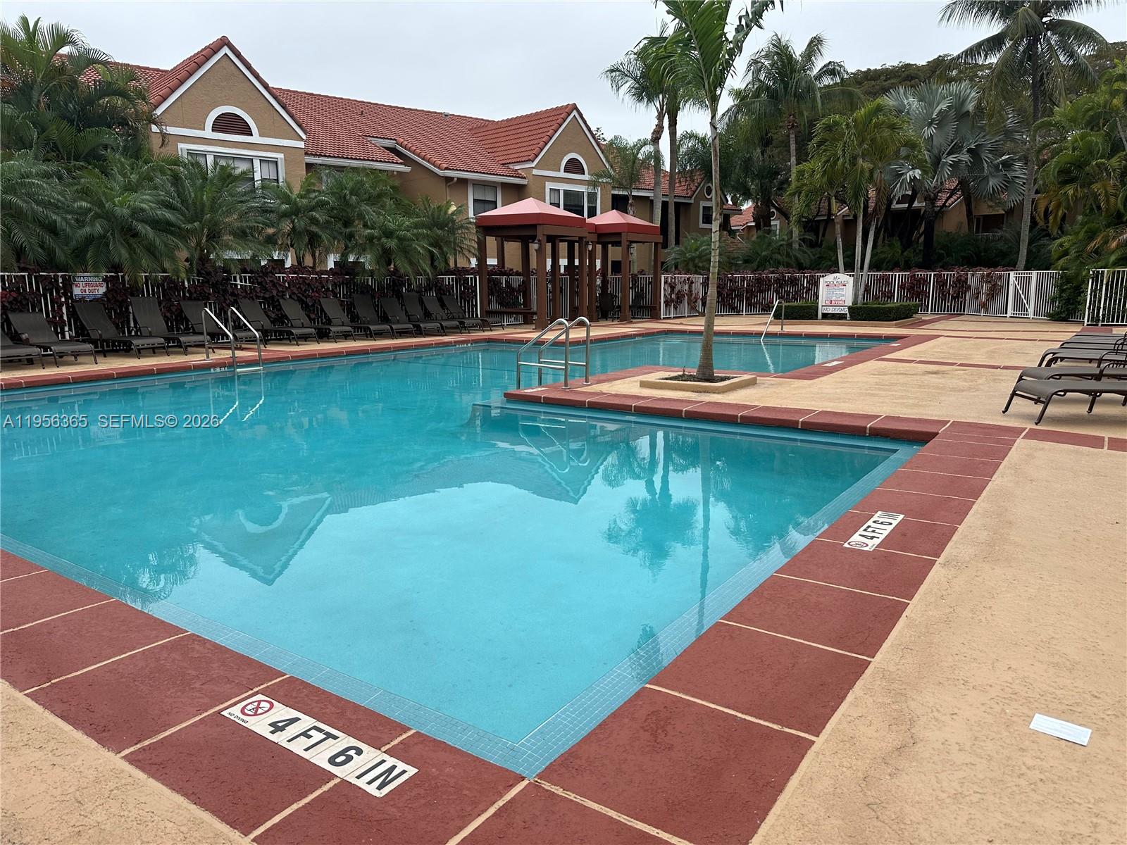 15560 Southwest 104th Terrace, Unit 625 Miami, FL 33196 - Photo 2 of 14 a view of a swimming pool with a patio