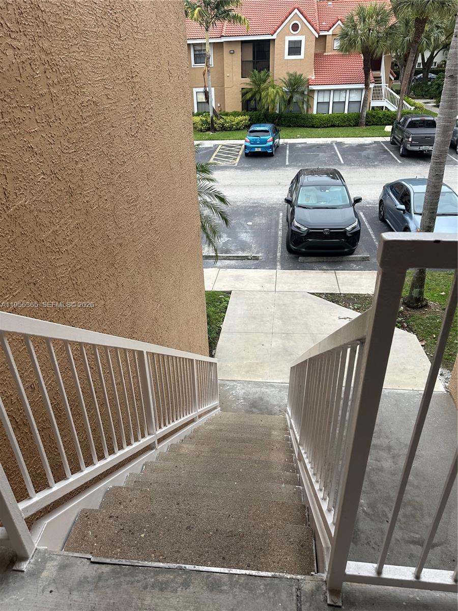 15560 Southwest 104th Terrace, Unit 625 Miami, FL 33196 - Photo 4 of 14 a view of a patio with couple of cars parked in front of it