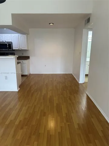 a view of a kitchen with wooden floor