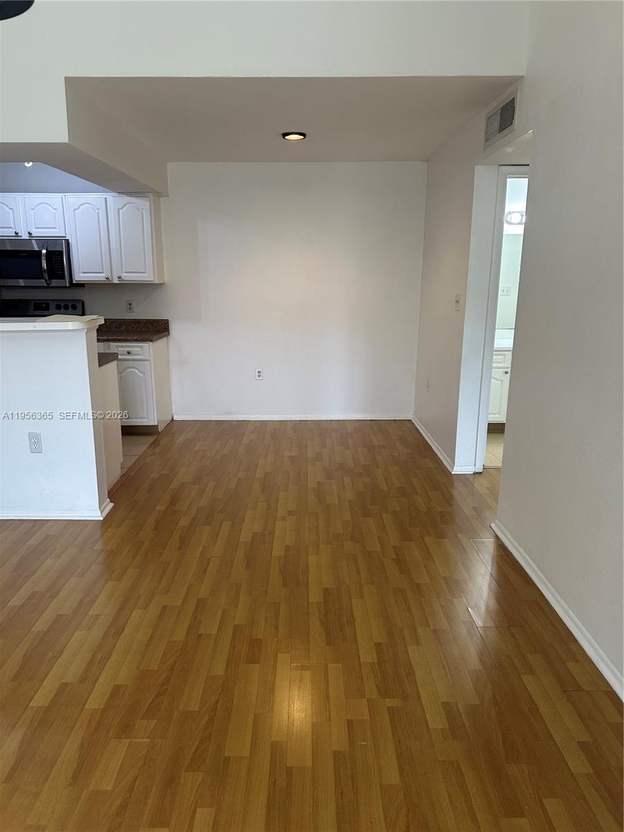 15560 Southwest 104th Terrace, Unit 625 Miami, FL 33196 - Photo 8 of 14 a view of a kitchen with wooden floor
