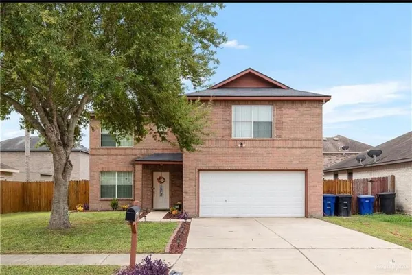a front view of a house with yard and garage