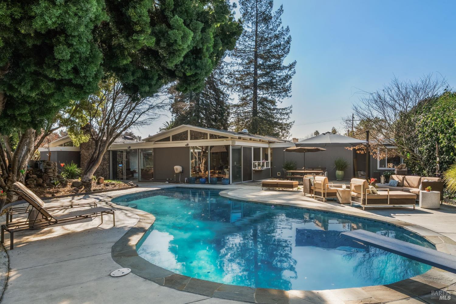a view of a house with backyard patio and sitting area