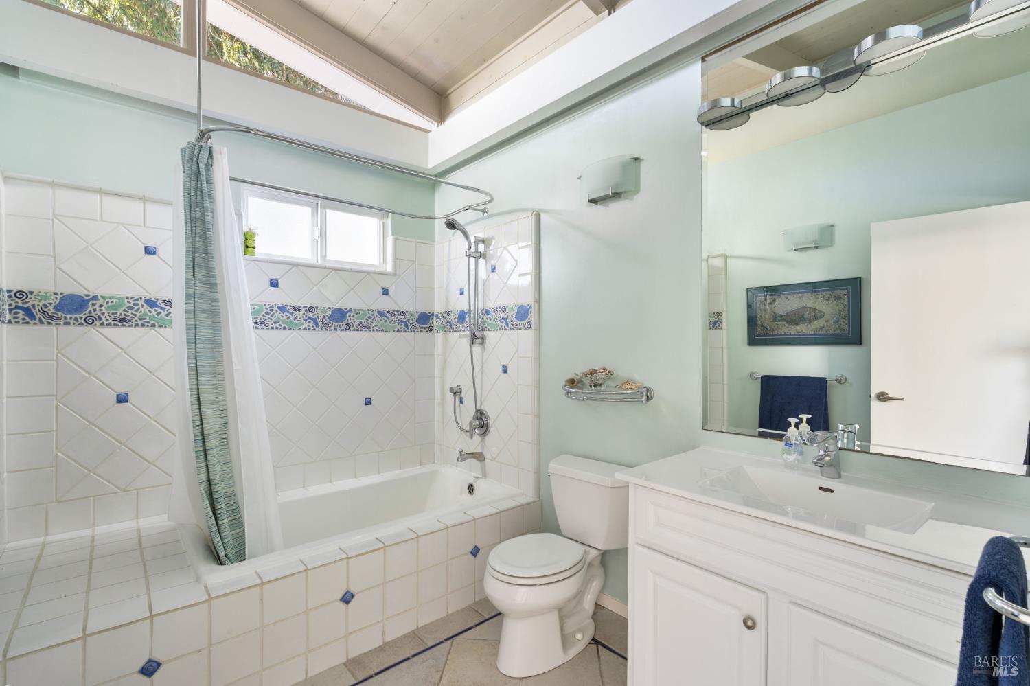 43 La Crescenta Way San Rafael, CA 94901 - Photo 21 of 28 a bathroom with a granite countertop sink a toilet a mirror and shower
