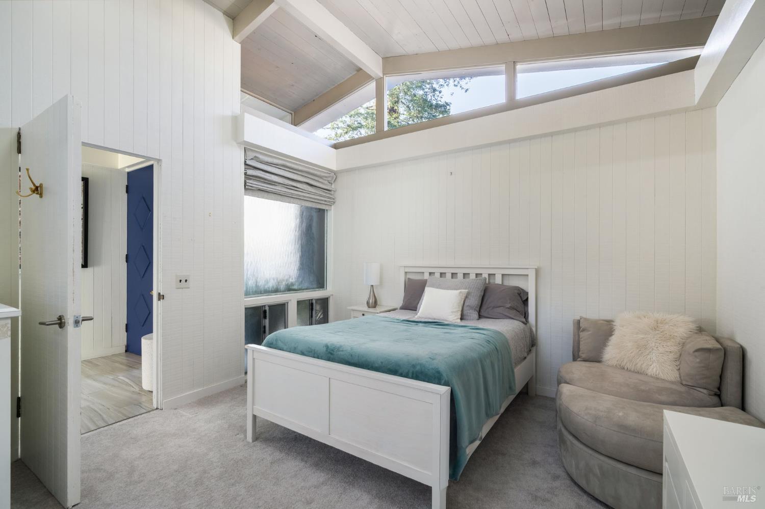 43 La Crescenta Way San Rafael, CA 94901 - Photo 22 of 28 a spacious bedroom with a bed and a couch