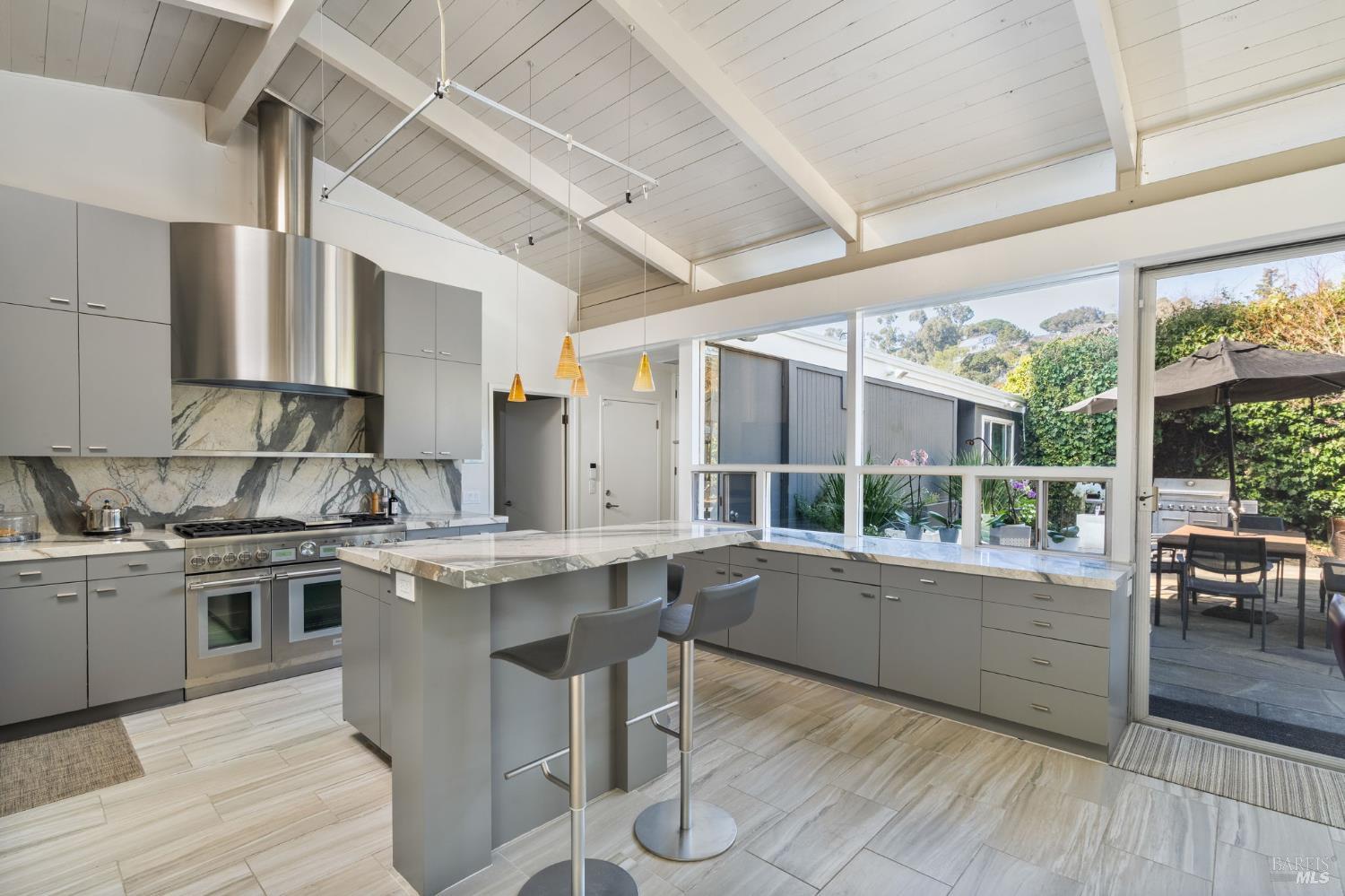 43 La Crescenta Way San Rafael, CA 94901 - Photo 6 of 28 a kitchen with stainless steel appliances granite countertop a stove and wooden floors