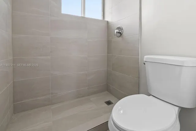 a bathroom with a toilet and shower