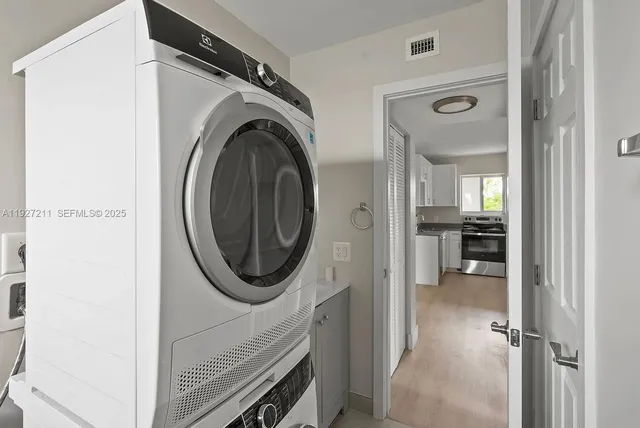 a view of a hallway with washer and dryer