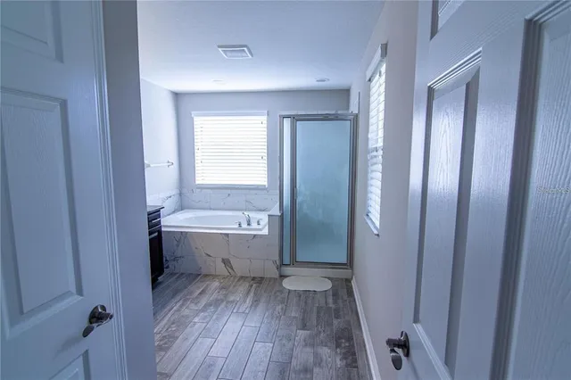 a bathroom with a bathtub and shower