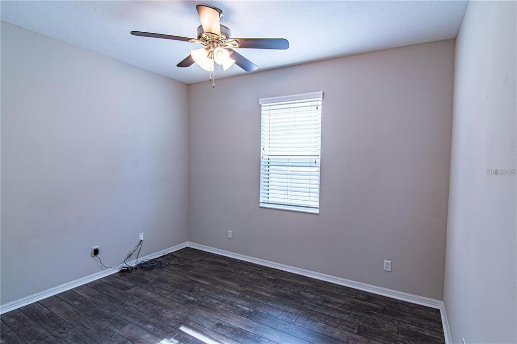 1977 Nature View Drive Lutz, FL 33558 - Photo 5 of 18 an empty room with a window and a fan