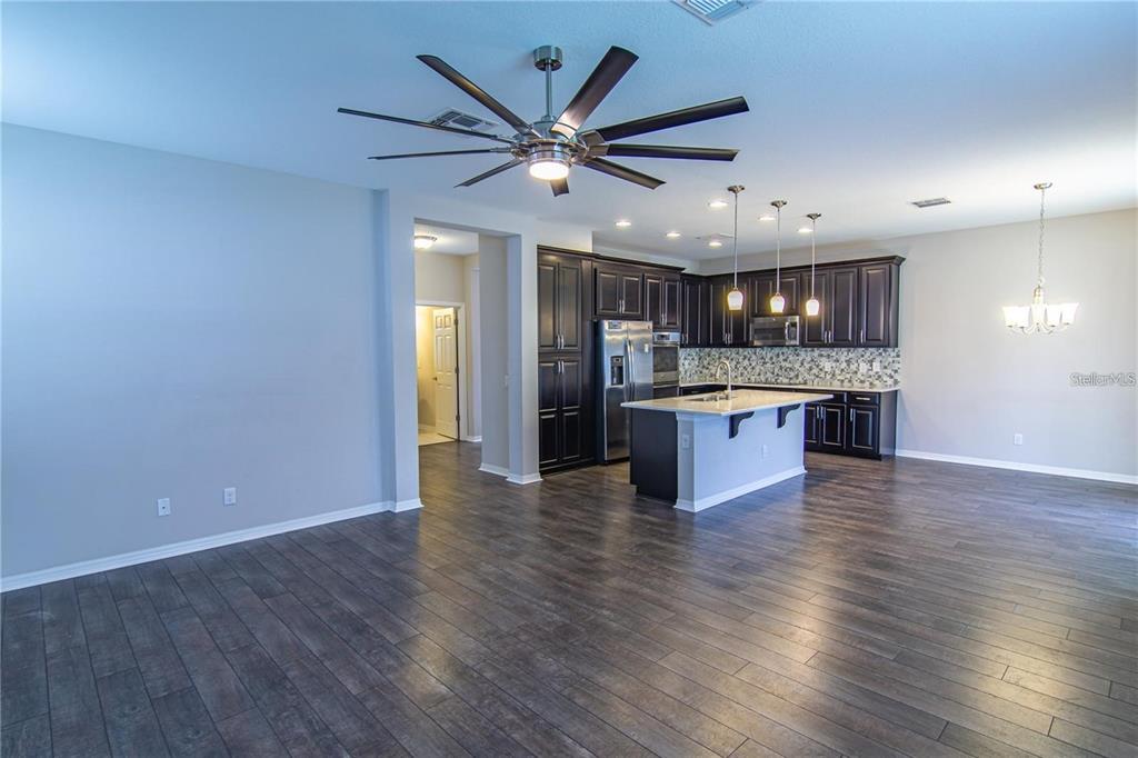 1977 Nature View Drive Lutz, FL 33558 - Photo 10 of 18 an open kitchen with a refrigerator and a stove top oven
