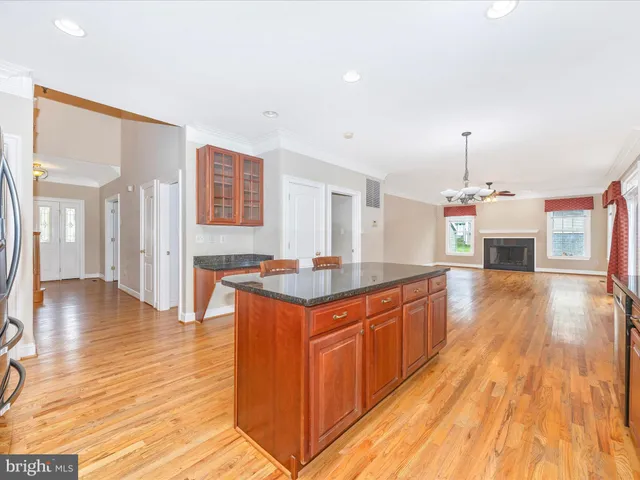 a kitchen with stainless steel appliances granite countertop a sink stove and wooden floor