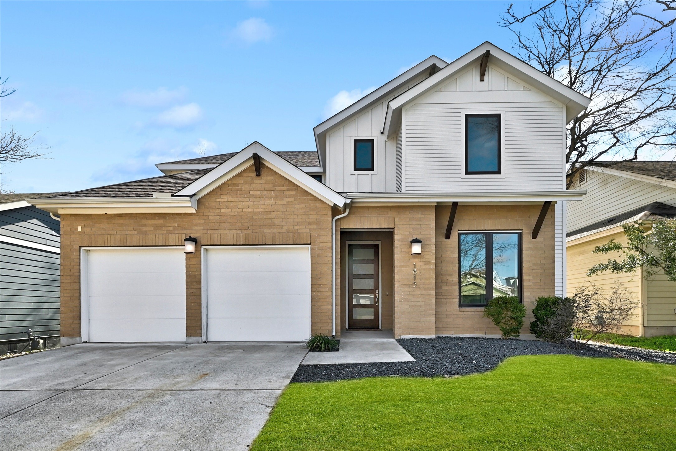 a front view of a house with a yard and garage