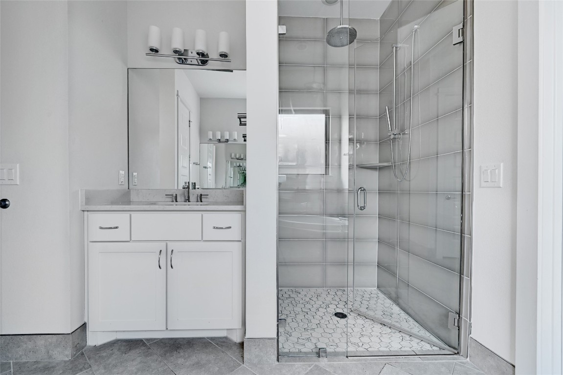 1815 West 38th Street Austin, TX 78731 - Photo 12 of 25 a bathroom with a shower sink and mirror