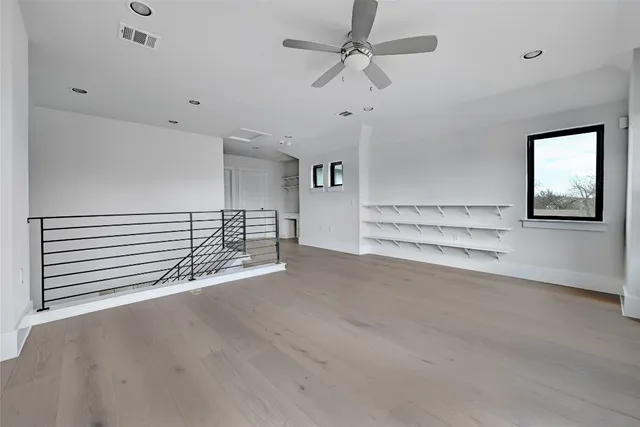 an empty room with a empty space and windows